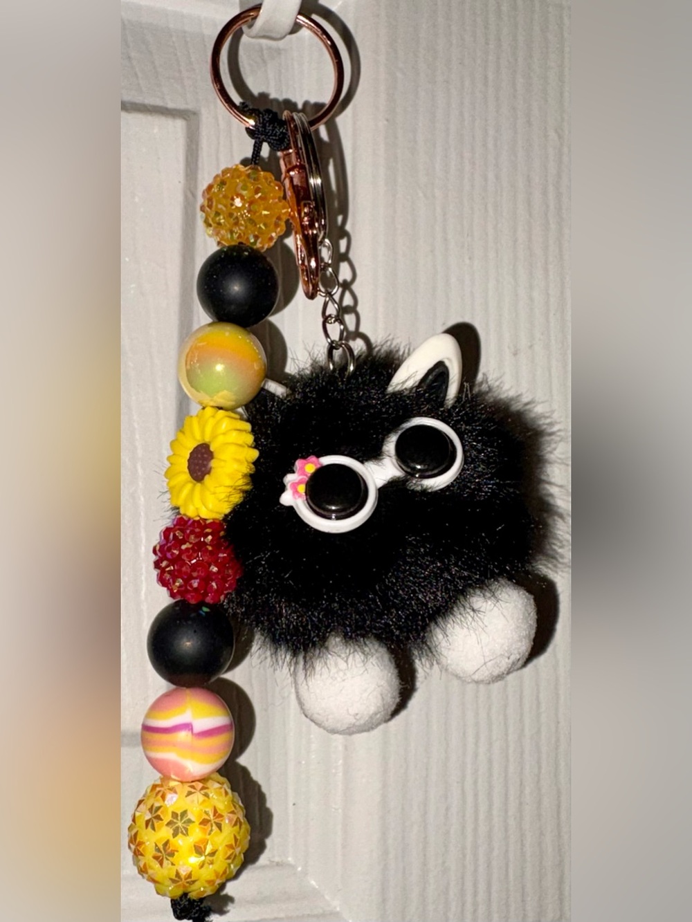 Yellow and black beaded sunflower keychain bag charm with fluffy cat charm